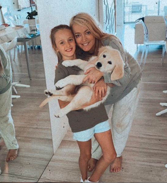 Jackie O Henderson and her daughter Kitty with a dog