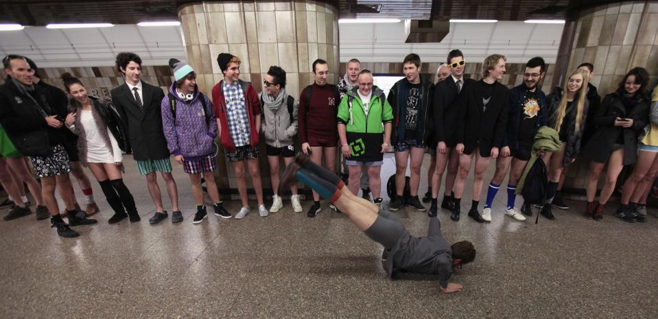 Passengers, not wearing pants, perform as they wait for a subway train during the "No Pants Subway Ride" in Prague January 12, 2014. The event is an annual flash mob and occurs in different cities around the world in January, according to its organisers. REUTERS/David W Cerny (CZECH REPUBLIC - Tags: TRANSPORT SOCIETY ANNIVERSARY)