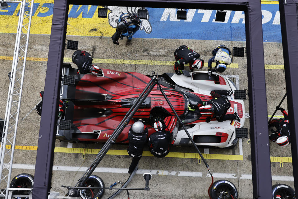 Mechanics refuel the Porsche Penske Motorsport team car, a Porsche 963, driven by Australia's Matt Campbell, Denmark's Michael Christensen and France's Frédéric Makowiecki during the 24-hour Le Mans endurance race in Le Mans, western France, Sunday, June 16, 2024. (AP Photo/Jeremias Gonzalez)