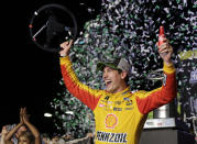 Joey Logano waves his steering wheel as confetti flies after winning the NASCAR Cup Series Championship auto race at the Homestead-Miami Speedway, Sunday, Nov. 18, 2018, in Homestead, Fla. (AP Photo/Terry Renna)