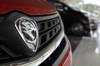 A Proton logo is seen on a car at its headquarters in Subang Jaya