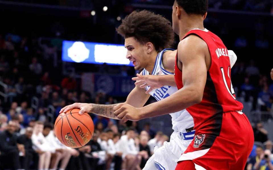Duke’s Tyrese Proctor (5) drives around N.C. State’s Casey Morsell (14) during the first half of N.C. State’s game against Duke in the quarterfinal round of the 2024 ACC Men’s Basketball Tournament at Capital One Arena in Washington, D.C., Thursday, March 14, 2024. Ethan Hyman/ehyman@newsobserver.com