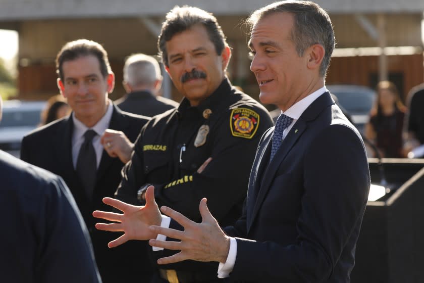 LOS ANGELES, CA - FEBRUARY 11, 2020 Los Angeles Mayor Eric Garcetti, right, with LA City Fire Department (LAFD) Chief Ralph Terrazas, left, talk to Firefighters before a press conference to announce the expansion of the LAFD's Fast Response Vehicle (FRV) program. The LAFD now has four FRV's in service citywide, which provide a flexible, multi- mission resource to respond to fire and emergency medical service calls. (Al Seib / Los Angeles Times)