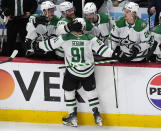 Dallas Stars center Tyler Seguin is congratulated after his empty-net goal by, from left, left wing Mason Marchment and centers Joe Pavelski, Wyatt Johnston and Roope Hintz during the third period of Game 3 of an NHL hockey Stanley Cup playoff series against the Colorado Avalanche on Saturday, May 11, 2024, in Denver. (AP Photo/David Zalubowski)