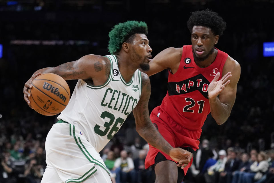 Boston Celtics guard Marcus Smart (36) drives to the basket against Toronto Raptors forward Thaddeus Young (21) during the first half of an NBA preseason basketball game Wednesday, Oct. 5, 2022, in Boston. (AP Photo/Charles Krupa)