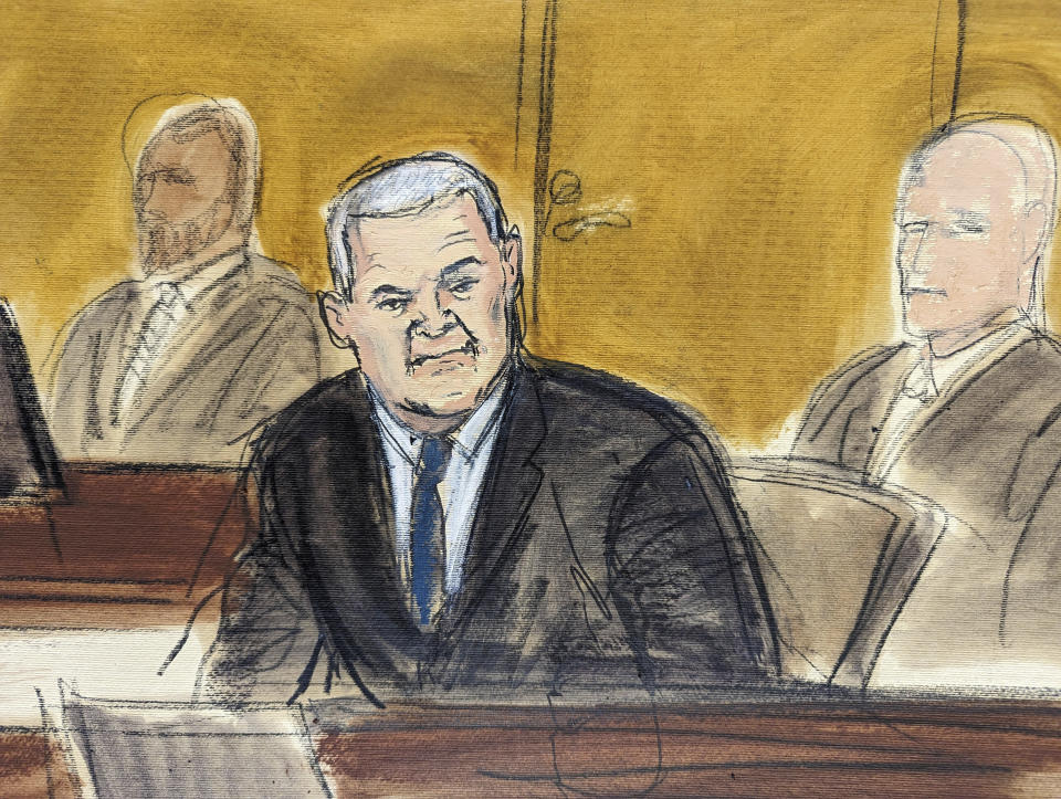 In this courtroom sketch, Genaro García Luna, center, is flanked by US Marshals prior to the verdict in his trial,, Tuesday, Feb. 21, 2023, in federal court in New York. The former Mexican presidential cabinet member was convicted in the U.S. Tuesday of taking massive bribes to protect the violent drug cartels he was tasked with combating. (AP Photo/Elizabeth Williams)