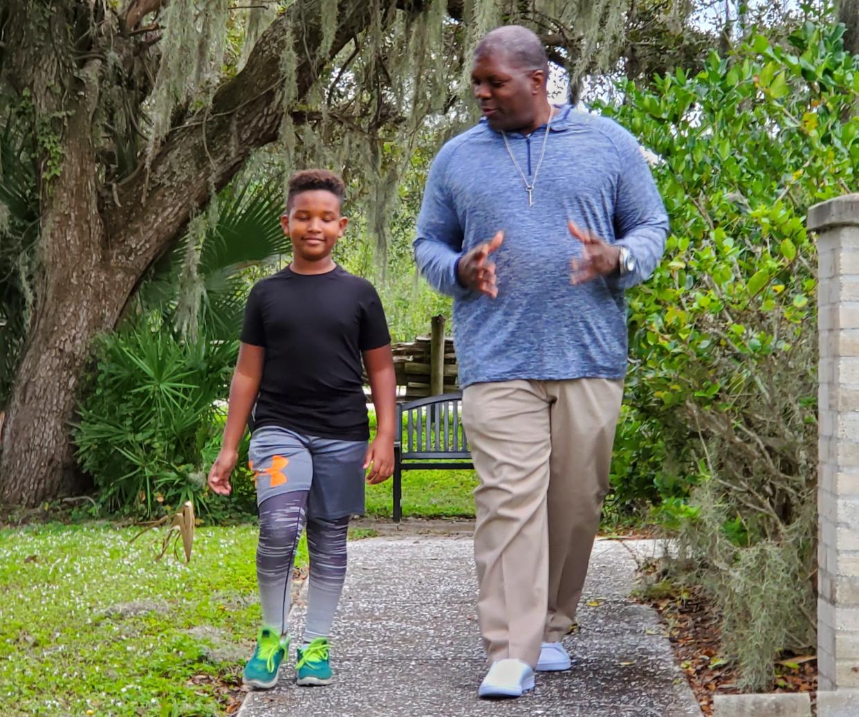 Big Brother of the Year Carlos Bates and Little Brother Mihretu enjoy spending time at the park. Bates has volunteered with Big Brothers Big Sisters of the Sun Coast since 2010.