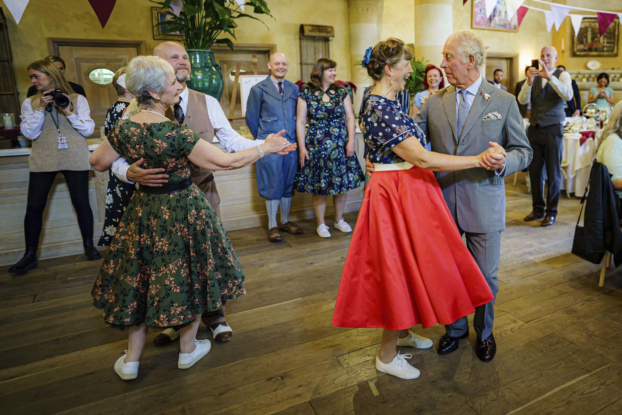 Britain's Prince Charles dances with Bridget Tibbs during a Jubilee tea dance hosted by The Prince's Foundation to mark the Platinum Jubilee at Highgrove near Tetbury, Gloucestershire, England, Tuesday, May 31, 2022.