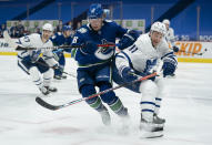 Vancouver Canucks center Adam Gaudette (96) works against Toronto Maple Leafs left wing Zach Hyman (11) during the second period of an NHL hockey game Thursday, March 4, 2021, in Vancouver, British Columbia. (Jonathan Hayward/The Canadian Press via AP)