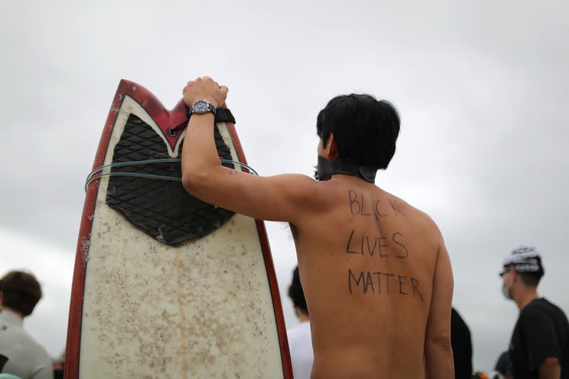 Panpan Wang, 37, attends the Black Girls Surf paddle-out in memory of George Floyd, who died in Minneapolis police custody, in Santa Monica