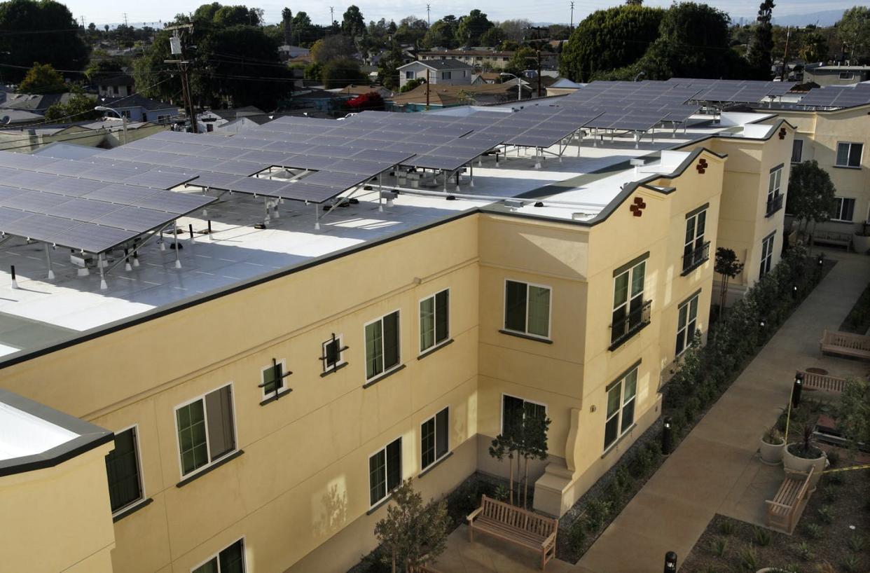 <span class="caption">Solar panels on the roof of the Casa Dominguez low-income housing development in East Rancho Dominguez, Calif.</span> <span class="attribution"><a class="link " href="https://www.gettyimages.com/detail/news-photo/the-solar-panels-on-the-roof-of-the-complex-in-casa-news-photo/566068839" rel="nofollow noopener" target="_blank" data-ylk="slk:Lawrence K. Ho/Los Angeles Times via Getty Images;elm:context_link;itc:0;sec:content-canvas">Lawrence K. Ho/Los Angeles Times via Getty Images</a></span>