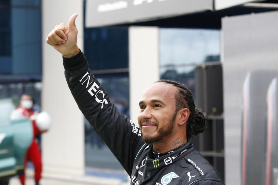 Mercedes driver Lewis Hamilton of Britain, reacts to the crowds after the end of qualifying for Sunday's Formula One Turkish Grand Prix at the Intercity Istanbul Park circuit in Istanbul, Turkey, Saturday, Oct. 9, 2021. Hamilton who took pole position will start 10th due to a penalty with Mercedes driver Valtteri Bottas of Finland who came second promoted to pole. (Umit Bektas/Pool Photo via AP)