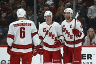 Carolina Hurricanes right wing Andrei Svechnikov (37) celebrates his goal against the Arizona Coyotes with defenseman Joel Edmundson (6) and center Jordan Staal (11) during the second period of an NHL hockey game Thursday, Feb. 6, 2020, in Glendale, Ariz. (AP Photo/Ross D. Franklin)