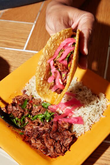 LOS ANGELES, CA - MAY 20 2023: The Birria Plate at The Saucy Chick / Goat Mafia has everything you need to build your own Birria Tacos. This Birria recipe has been passed down through 4 generations and here it is served with cumin rice, pickled onions, and Kernel of Truth corn tortillas. (Oscar Mendoza/LA Times)