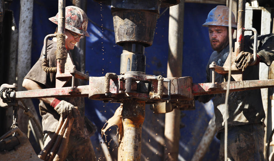 FILE - In this Feb. 21, 2012, file photo, oil field workers drill into the Gypsum Hills near Medicine Lodge, Kan., using horizontal drilling and a technique known as hydraulic fracturing, or “fracking,” to coax out oil and gas. Illinois legislation is advancing that would regulate decades-old but debated technology used to reach previously inaccessible natural gas reserves deep underground. The Illinois state Senate on Thursday, April 26, 2012, unanimously sent to the House a bill addressing hydraulic fracturing, or fracking. That technology involves using mixtures of water, sand and chemicals to free below-ground energy reserves. (AP Photo/Orlin Wagner, File)