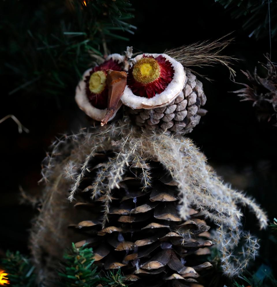 Owls made of pine cones, ornamental grass, pretzel beans and dried flower heads are among the hand-crafted ornaments on the natural Christmas trees at Green Bay Botanical Garden.