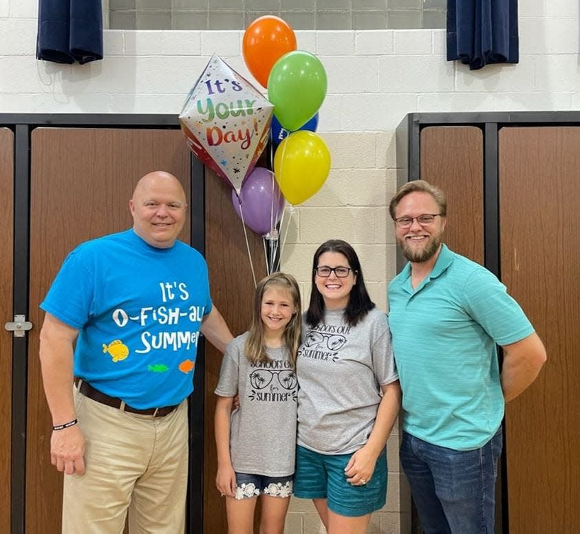 Arlyn Mae Morris, an incoming fourth grader at West Main Elementary School, has been selected as mini marshal of the 2022 Ravenna Balloon A-Fair. From left are Lee Smith, principal of West Main Elementary School, Arlyn, and her parents, Melissa and Larry.