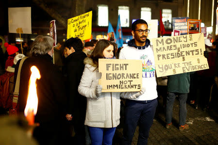 People attend an Anti-Trump demonstration to protest U.S. President's coming to the World Economic Forum of Davos, in Geneva, Switzerland January 23, 2018. REUTERS/Pierre Albouy