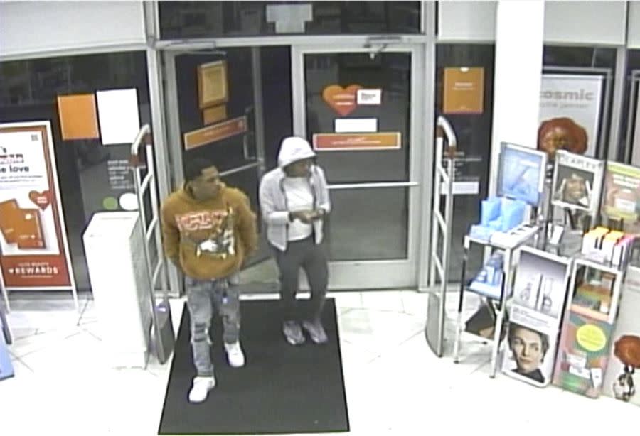 Two people enter an ULTA Beauty store's front doors at Springdale Mall in Mobile, Alabama. 