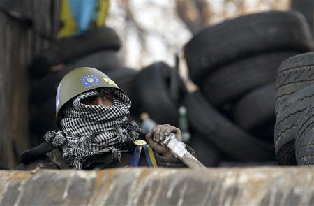 An anti-government protester is seen at the barricades in Kiev February 4, 2014. REUTERS/Vasily Fedosenko