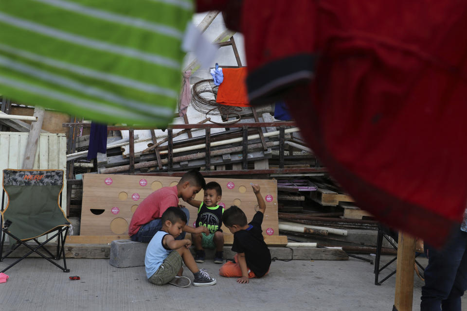 Migrant children play at the AMAR migrant shelter in Nuevo Laredo, Mexico, Wednesday, July 17, 2019. Asylum-seekers grappled to understand what a new U.S. policy that all but eliminates refugee claims by Central Americans and many others meant for their bids to find a better life in America amid a chaos of rumors, confusion and fear. (AP Photo/Marco Ugarte)