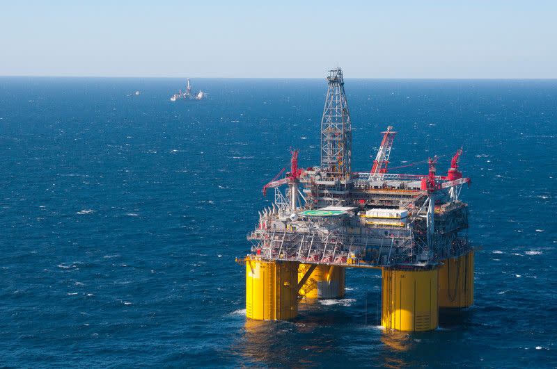 Shell's offshore platform Olympus, part of the company's Mars deepwater project, is pictured in the Mississippi Canyon area of the Gulf of Mexico in 2014. One of Shell's drillships is pictured in the background.  (Photo: <a href="https://creativehub.shell.com/web/7dee90c066297f6d/upstream--conventional-oil---gas--shales--deep-water/?mediaId=014E39A9-4BF5-47BE-AC4B8D2AC98BBF69" target="_blank">Mike Duhon Productions</a>)