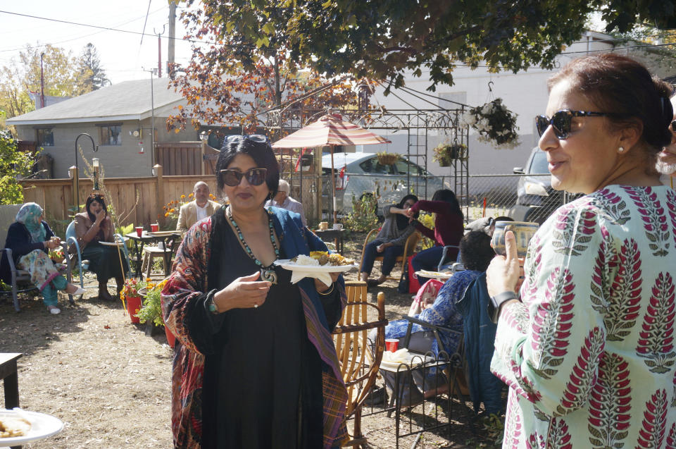 Kuhu Singh, left, and Kuljeet Kaur, right, gather at the Minneapolis house of two other members of the “India Coalition” group on Sunday, Oct. 9, 2022. Singh, who calls herself “culturally Hindu,” and Kaur, who’s Sikh, both worry that religious tensions in India are spreading to Indian diaspora communities like theirs in Minnesota. (AP Photo/Giovanna Dell’Orto)