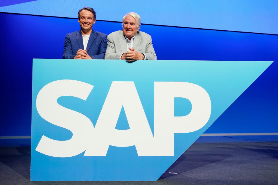 15 May 2024, Baden-Württemberg, Mannheim: Hasso Plattner (r), former Chairman of the Supervisory Board of the software group SAP, and Christian Klein, CEO of SAP, stand on the stage behind a logo of the software group at the Annual General Meeting. Among other things, the successor to the departing Chairman of the Supervisory Board Plattner is elected at the Annual General Meeting. Photo: Uwe Anspach/dpa (Photo by Uwe Anspach/picture alliance via Getty Images)