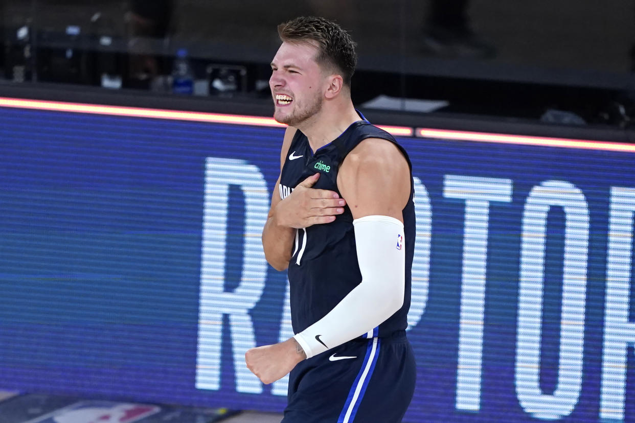 Dallas Mavericks' Luka Doncic celebrates after making a winning 3-point basket against the Los Angeles Clippers during overtime of an NBA basketball first round playoff game Sunday, Aug. 23, 2020, in Lake Buena Vista, Fla. The Mavericks won 135-133 in overtime. (AP Photo/Ashley Landis, Pool)