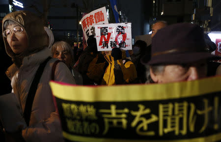 Protesters hold banners during an anti-nuclear rally in front of the headquarters of Tokyo Electric Power Co (TEPCO), the operator of the tsunami-crippled Fukushima Daiichi nuclear plant, a day before the five-year anniversary of the disaster, in Tokyo, Japan, March 10, 2016. The banner reads in Japanese "No nuclear power plant. No restart." (back). REUTERS/Yuya Shino