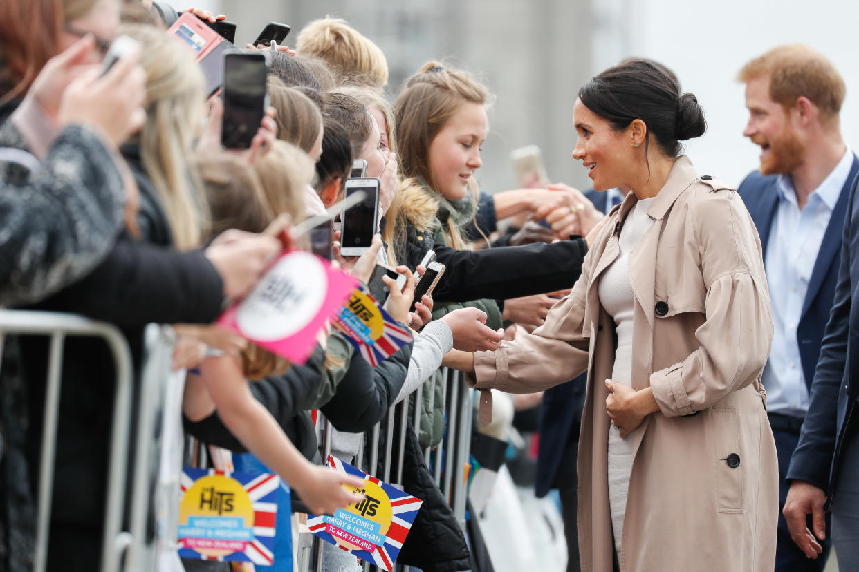 Meghan Markle has been cradling her baby bump [Photo: Getty]