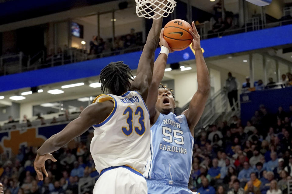 North Carolina forward Harrison Ingram (55) drives to the net against Pittsburgh center Federiko Federiko (33) during the second half of an NCAA college basketball game Tuesday, Jan. 2, 2024, in Pittsburgh. (AP Photo/Matt Freed)