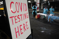 A sign indicating a COVID-19 testing site is displayed inside a parking garage in West Nyack, N.Y., Monday, Nov. 30, 2020. The site was only open to students and staff of Rockland County schools in an effort to test enough people to keep the schools open for in-person learning. (AP Photo/Seth Wenig)