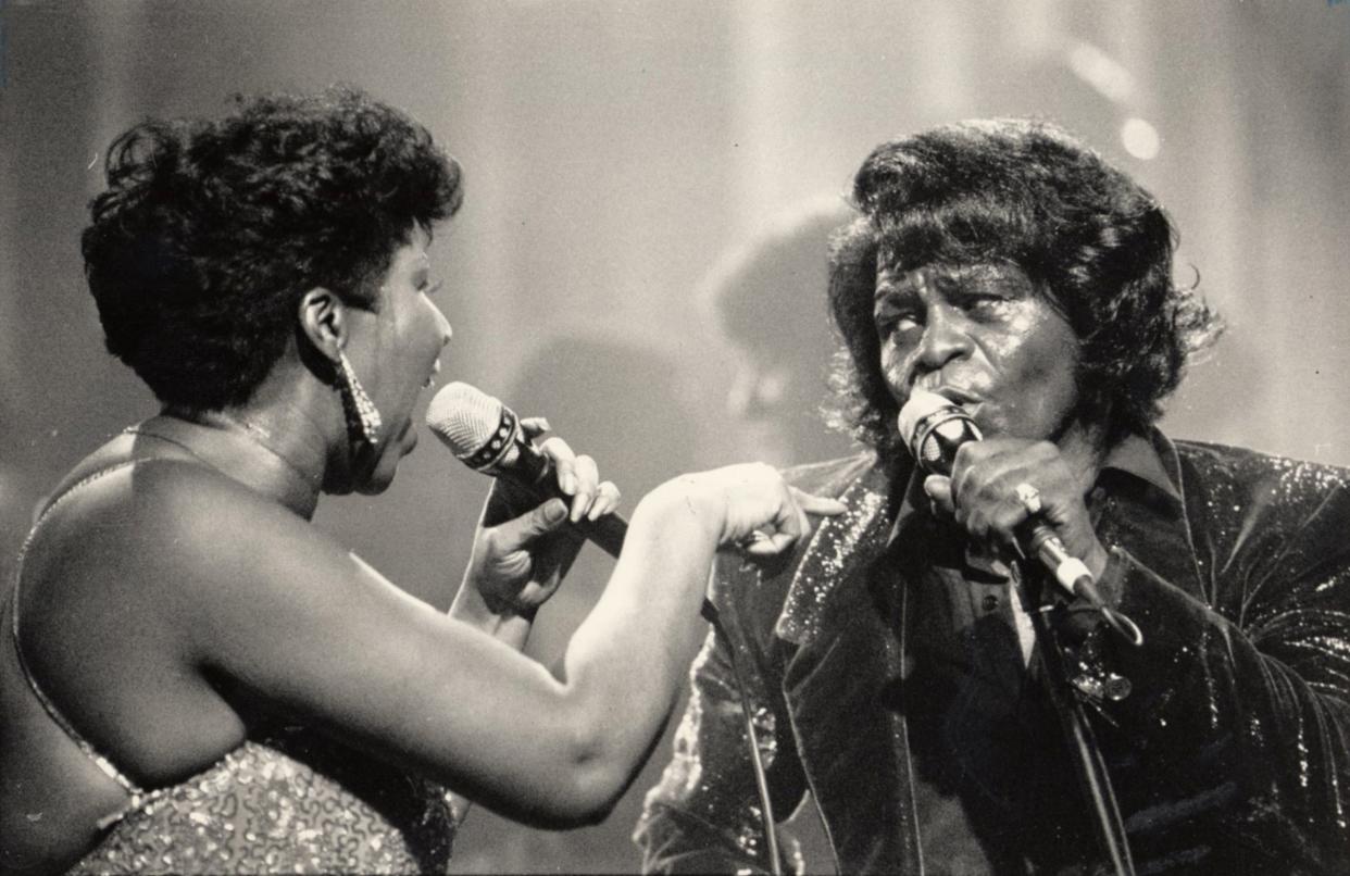 James Brown, right, performs with Aretha Franklin in Detroit in January 1987. Brown got his start recording with King Records in Cincinnati's Evanston neighborhood.