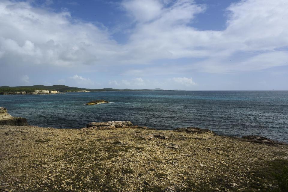 This Jan. 13, 2017 photo, shows the ocean view from the Ferro Port lighthouse at Verdiales Key point on the south coast of Vieques island, Puerto Rico. This year the Navy plans to scour the seabed to map areas containing unexploded ordnance to be removed by divers and robots, eventually opening new beaches and reefs to swimmers and divers. (AP Photo/Carlos Giusti)