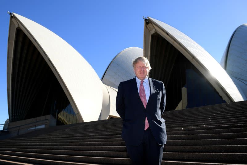 FILE PHOTO: British Foreign Secretary Boris Johnson stands on the steps of the Sydney Opera House during an official visit in Sydney, Australia