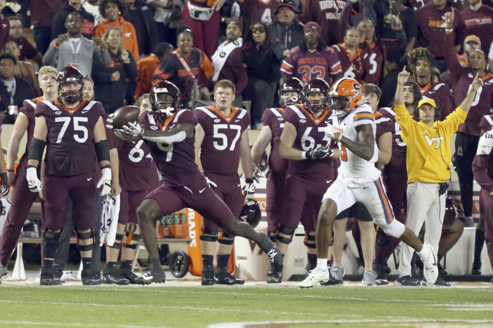 Virginia Tech's Da'Quan Felton (9) catches a pass for a touchdown, next to Syracuse defender Isaiah Johnson (3) during the first half of an NCAA college football game Thursday, Oct. 26, 2023, in Blacksburg, Va. (Matt Gentry-/The Roanoke Times via AP)