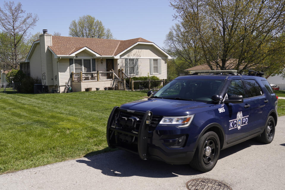 A police officer drives past the house Monday, April 17, 2023, where 16-year-old Ralph Yarl was shot Thursday when he went to the wrong house to pick up his younger brothers in Kansas City, Mo. (AP Photo/Charlie Riedel)