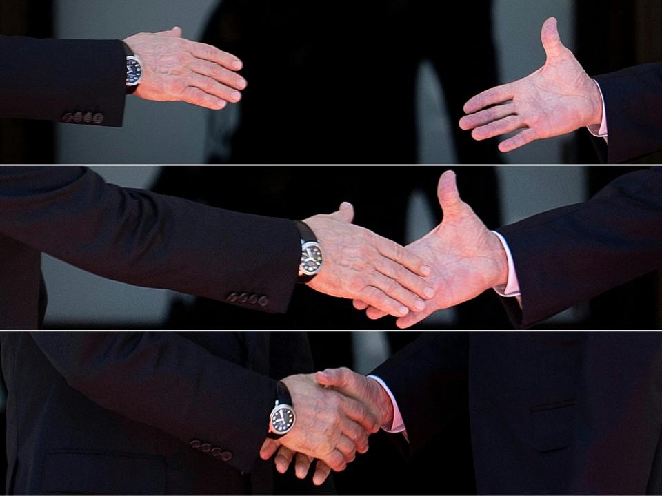 Russia’s president Vladimir Putin (left) and US president Joe Biden reaching out to shake hands before their meeting at Villa La Grange, Geneva (AFP/Getty)