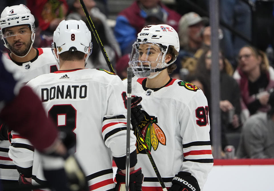 Chicago Blackhawks center Connor Bedard, right, confers with center Ryan Donato (8) and defenseman Seth Jones, left, in the second period of an NHL hockey game against the Colorado Avalanche, Monday, March 4, 2024, in Denver. (AP Photo/David Zalubowski)