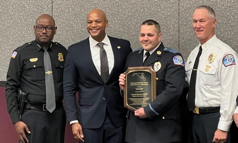 From left, Berlin Police Chief Arnold Downing, Gov. Wes Moore, 2022 Maryland "Top Cop" Cpl. Michael Schlaerth of the Sykesville Police Department, and Sykesville's Police Chief Michael Spaulding pose for a photograph in Ocean City on June 27, 2023. Schlaerth won the annual recognition from the Maryland Municipal League's Police Executive Association, in part due to his role in resolving a multistate theft case.