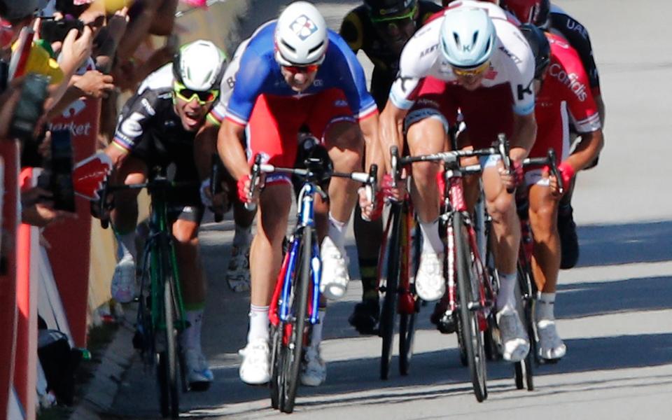 Mark Cavendish (left) is elbowed into the barriers by world champion Peter Sagan (not seen) - Credit: AP