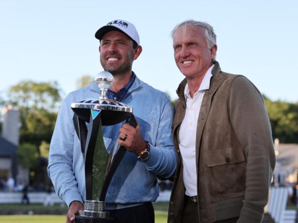 Charl Schwartzel poses with Greg Norman  (AFP via Getty Images)