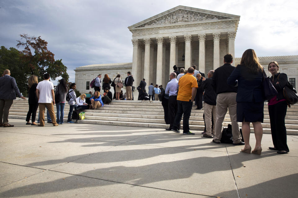 FILE - In this Oct. 13, 2015, file photo, people line up outside of the Supreme Court in Washington, Tuesday, Oct. 13, 2015, as the justices began to discuss sentences for young prison 'lifers.' In recent years, hundreds of people once destined to spend the rest of their lives in prison after being convicted of crimes as juveniles have gone free. That's due to Supreme Court decisions ruling that young people are capable of change and should be given a second chance. But so far the man whose case has been central to this change is still behind bars nearly six decades after his 1963 arrest. That may change Wednesday, Nov. 17, 2021, when a Louisiana parole board votes for the third time whether to grant 75-year-old Henry Montgomery parole. (AP Photo/Jacquelyn Martin, File)