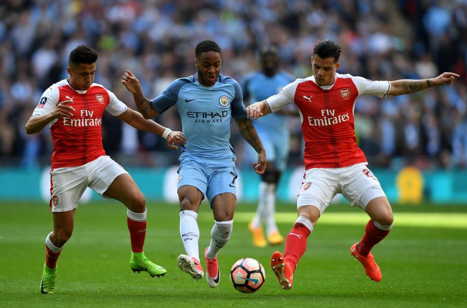  Raheem Sterling (C) of Manchester City controls the ball under pressure of Alexis Sanchez (L) and Granit Xhaka (R) of Arsenal during the Emirates FA Cup Semi-Final match between Arsenal and Manchester City at Wembley Stadium