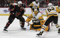 Pittsburgh Penguins goaltender Casey DeSmith (1) keeps his eye on the puck as Ottawa Senators' Chris Tierney (71) tries to shoot during the second period of an NHL hockey game in Ottawa, on Saturday, Nov. 13, 2021. (Justin Tang/The Canadian Press via AP)