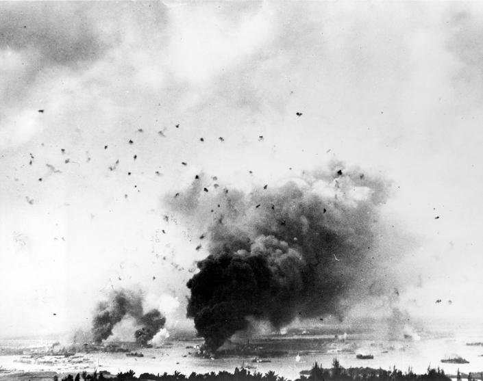 <p>Flak bursts of anti-aircraft shells pepper the skyline above rising smoke from the battleship USS Arizona during the Japanese raid on Pearl Harbor on Dec. 7, 1941. (U.S. Navy/National Archives/Handout via Reuters) </p>