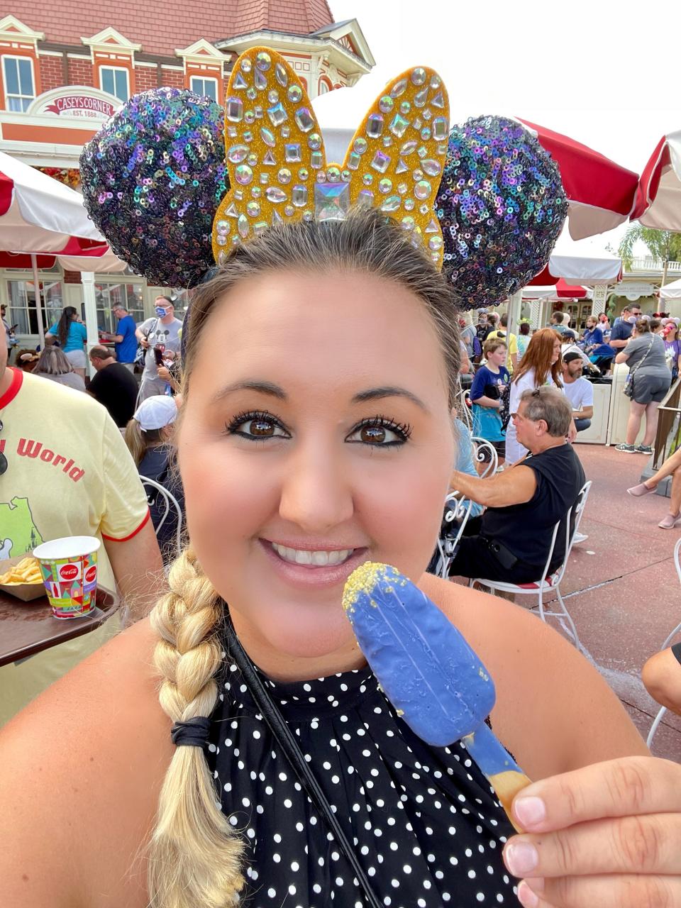 carly with food and ears in the new earidesent color at disney world 50th anniversary