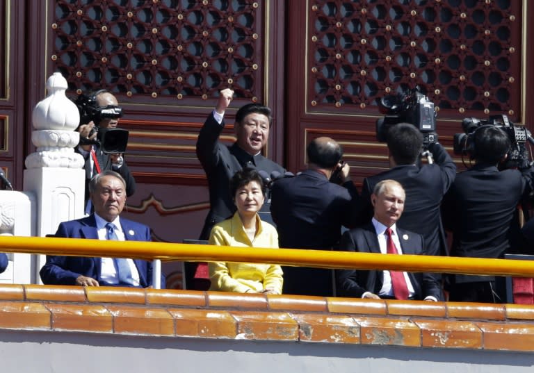 China's President Xi Jinping (centre, at rear) delivers a speech behind world leaders during a military parade in Beijing's Tiananmen Square on September 3, 2015