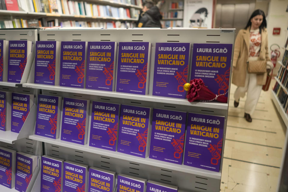 Copies of the book Sangue in Vaticano (Blood in The Vatican) by lawyer Laura Sgro', are displayed in the window of a bookshop during its launch in Rome, Tuesday, Nov. 29, 2022. The book is about the case of Swiss Guard Corporal Cedric Tornay who allegedly committed suicide in the Vatican after killing guards' commander Alois Estermann and his Venezuelan wife Gladys Meza Romero in 1998. (AP Photo/Andrew Medichini)